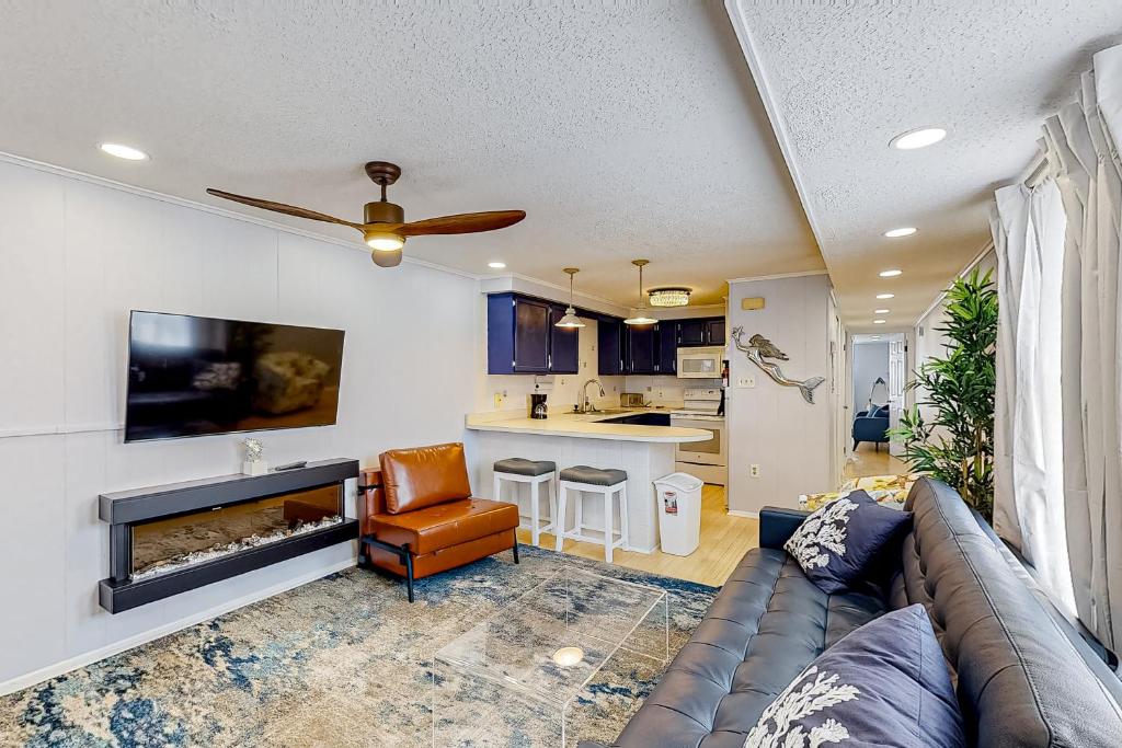 a living room with a couch and a fireplace at The Quarterdeck OC in Ocean City