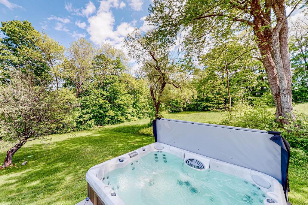 a hot tub in the middle of a yard at Town Farm Retreat in Ludlow