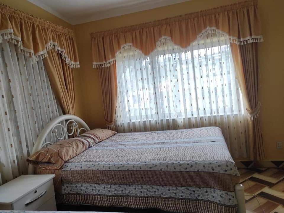 a bedroom with a bed in front of a window at Hostal Flores in La Paz