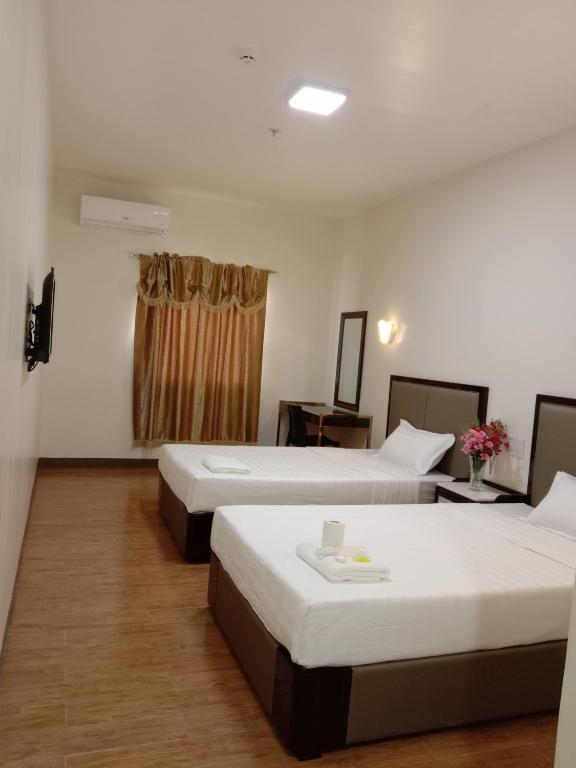 Postel nebo postele na pokoji v ubytování Meaco Royal Hotel- Lucena