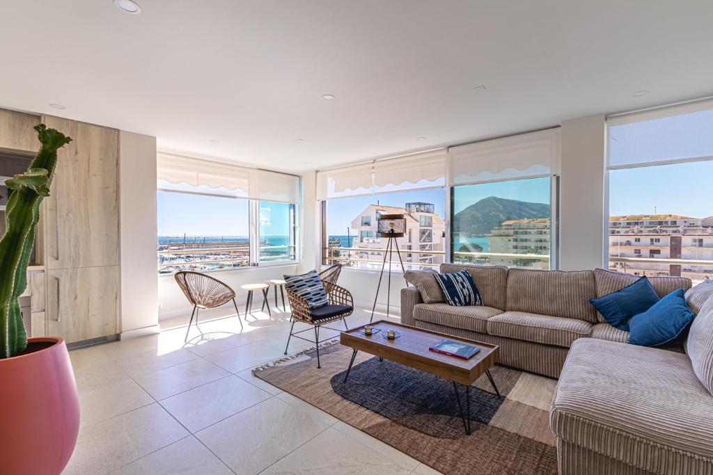 a living room with a couch and a table at Atico Puerto Sol in Altea