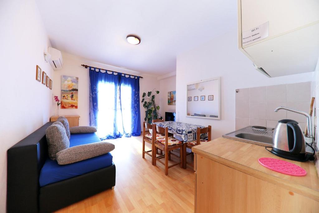 a kitchen and living room with a couch and a table at Comfortable apartment in Zadar with sea view, 60 m² in Zadar
