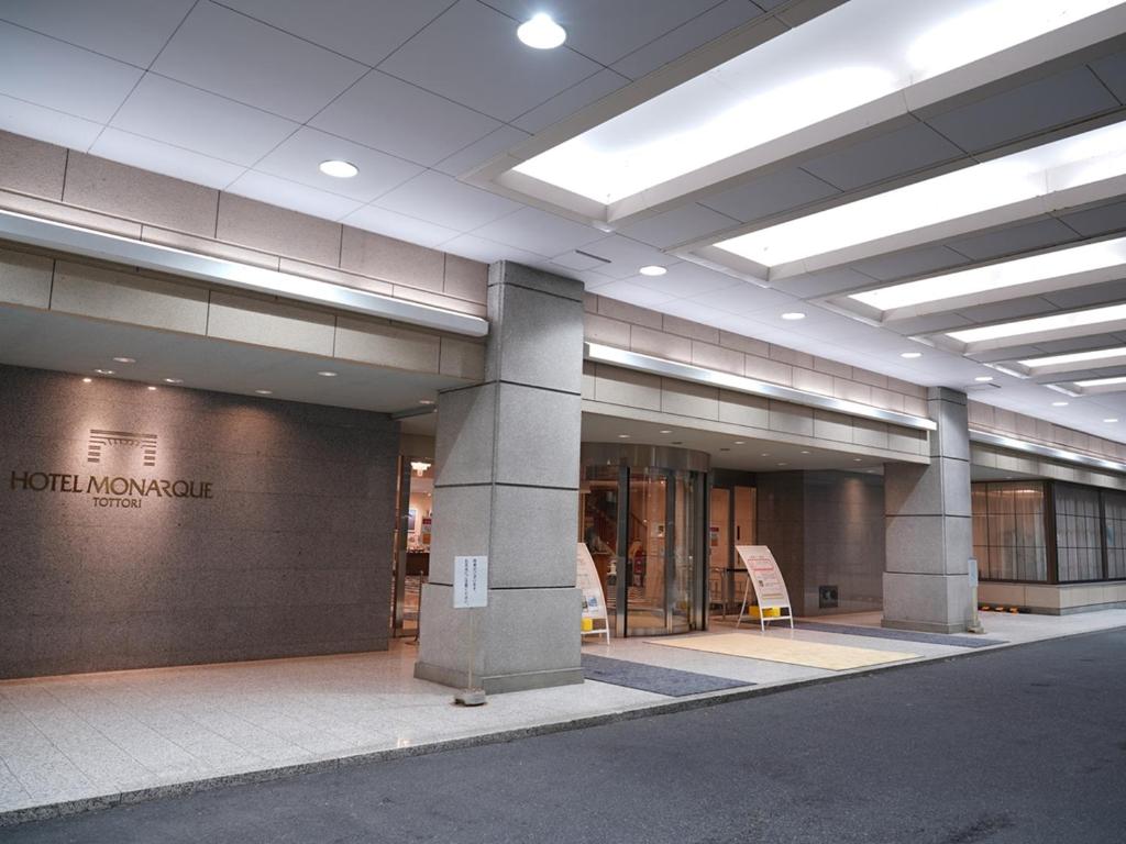 a lobby of a building with a sign on it at Hotel Monarque Tottori in Tottori