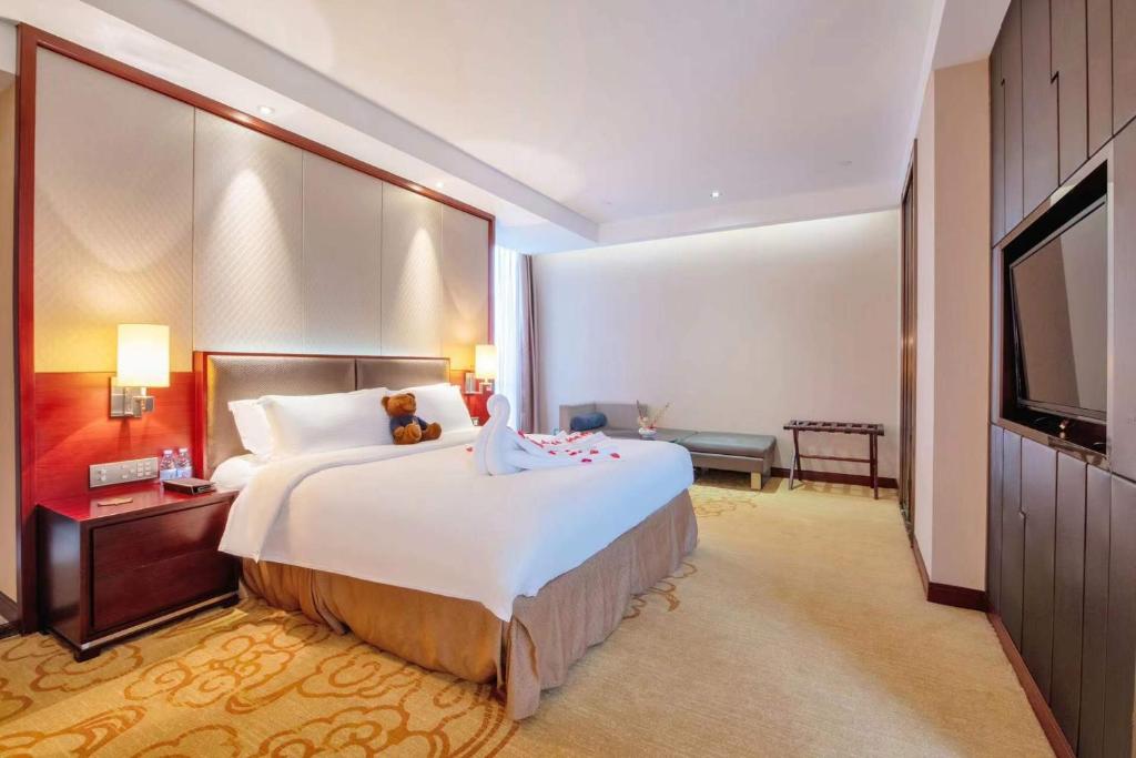 Postel nebo postele na pokoji v ubytování Shenzhen Avant-Garde Hotel