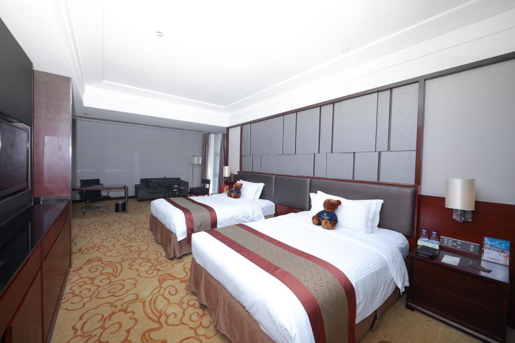 TV a/nebo společenská místnost v ubytování Shenzhen Avant-Garde Hotel