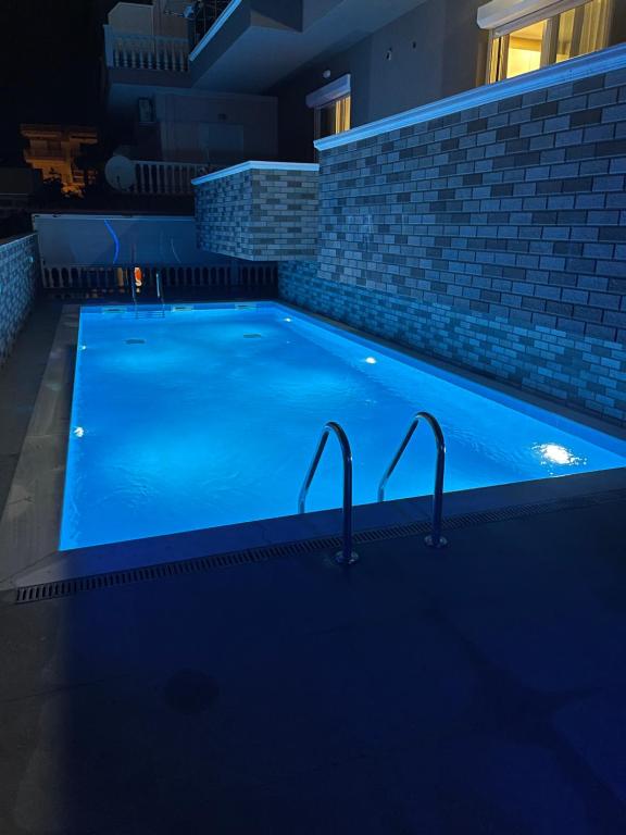 a large blue swimming pool in a building at Princess Luxury Suite 2 in Paralia Katerinis