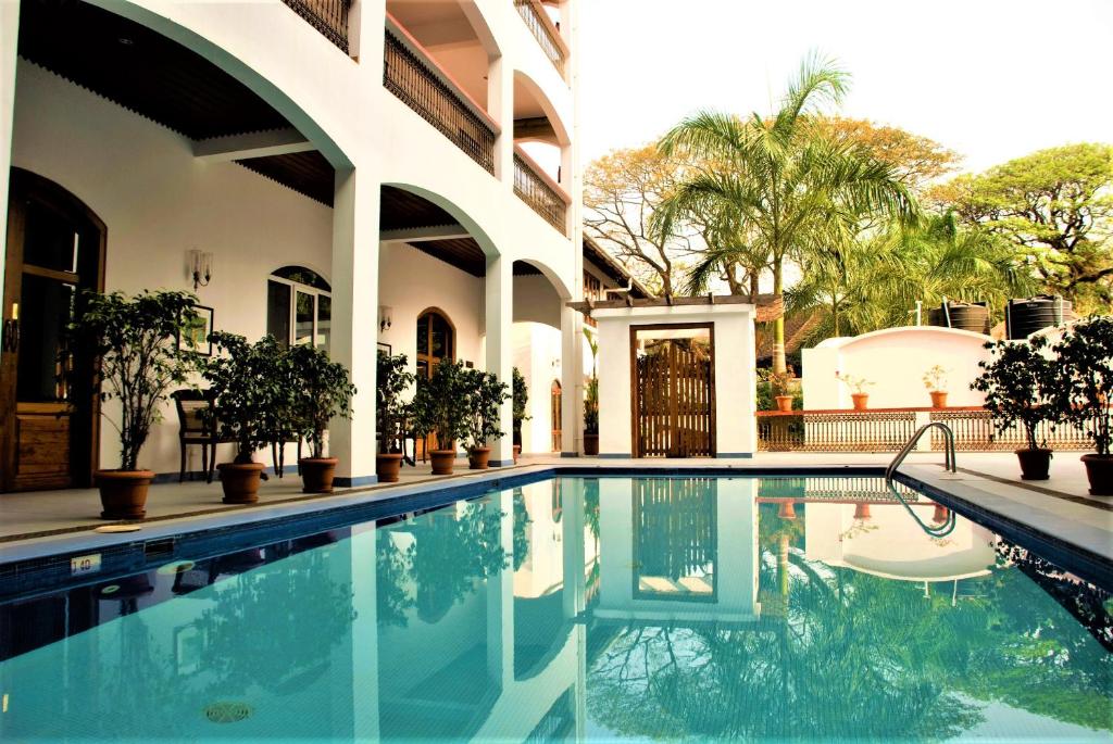 a swimming pool in front of a house at The Killians Boutique Hotel in Cochin