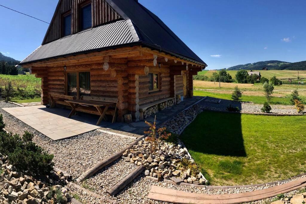 a log cabin with a bench in front of it at Chatka_Kasina in Kasina Wielka