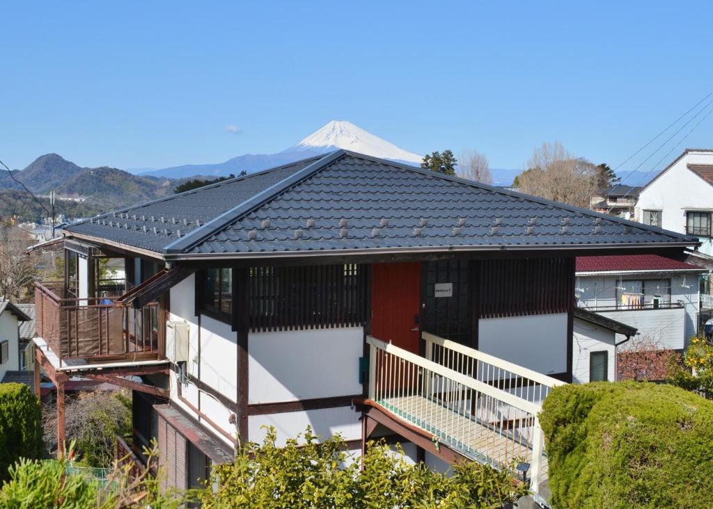 a house with a black roof and a balcony at Izu Ricca - Vacation STAY 83345 in Izunokuni