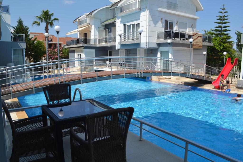 a large swimming pool with a slide in front of a building at Antalya belek Mermaid villas 3 bedrooms close the beach park 2 in Belek