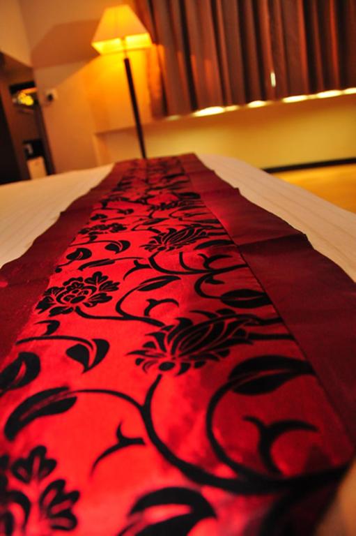 Postel nebo postele na pokoji v ubytování Tat Place Hotel