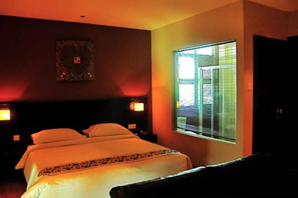 Postel nebo postele na pokoji v ubytování Tat Place Hotel