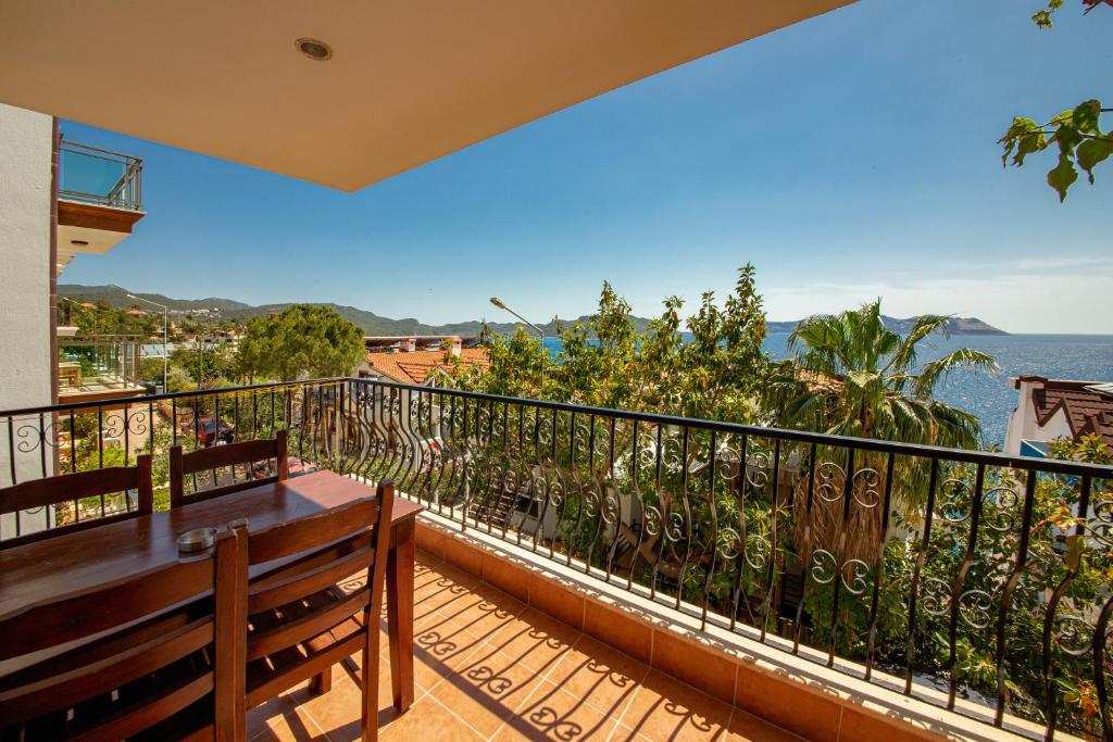 a balcony with a table and a view of the ocean at Lantana Aparts in Kaş