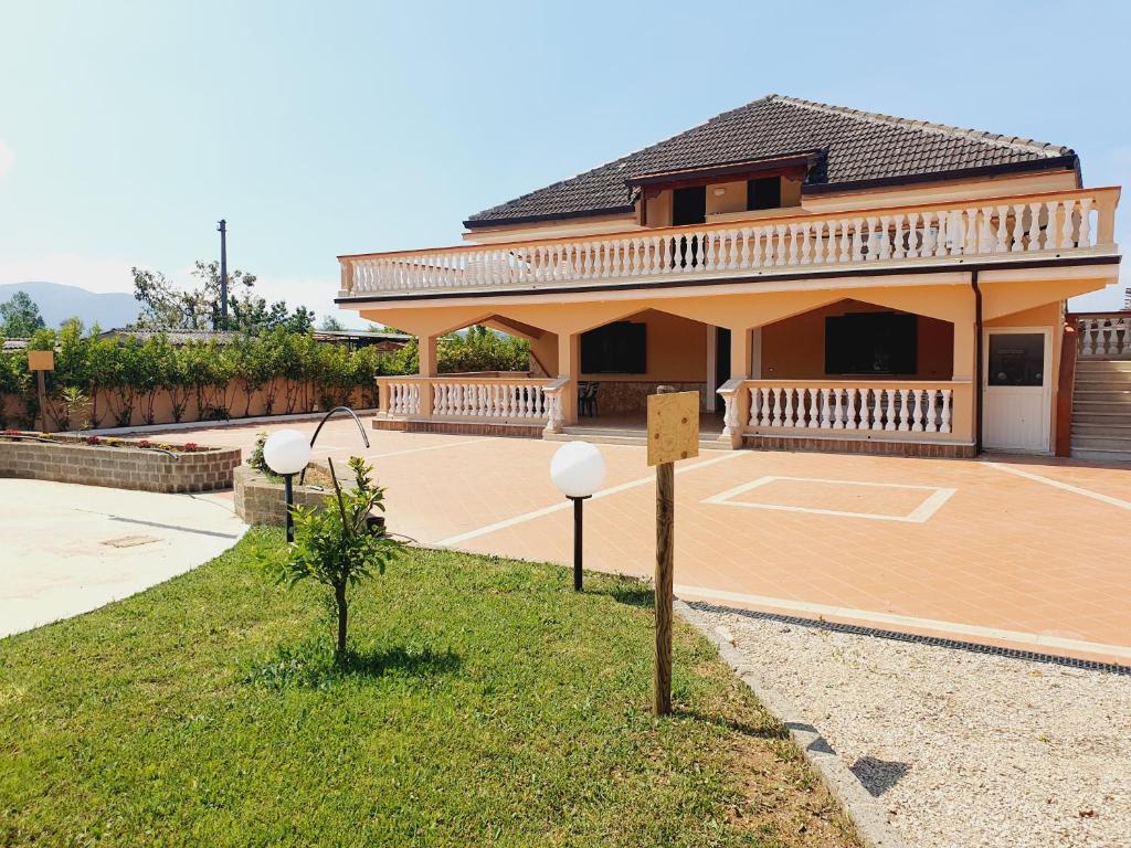 a large house with a basketball court in front of it at Villa Regina - Sperlonga Vertice Rooms in Sperlonga