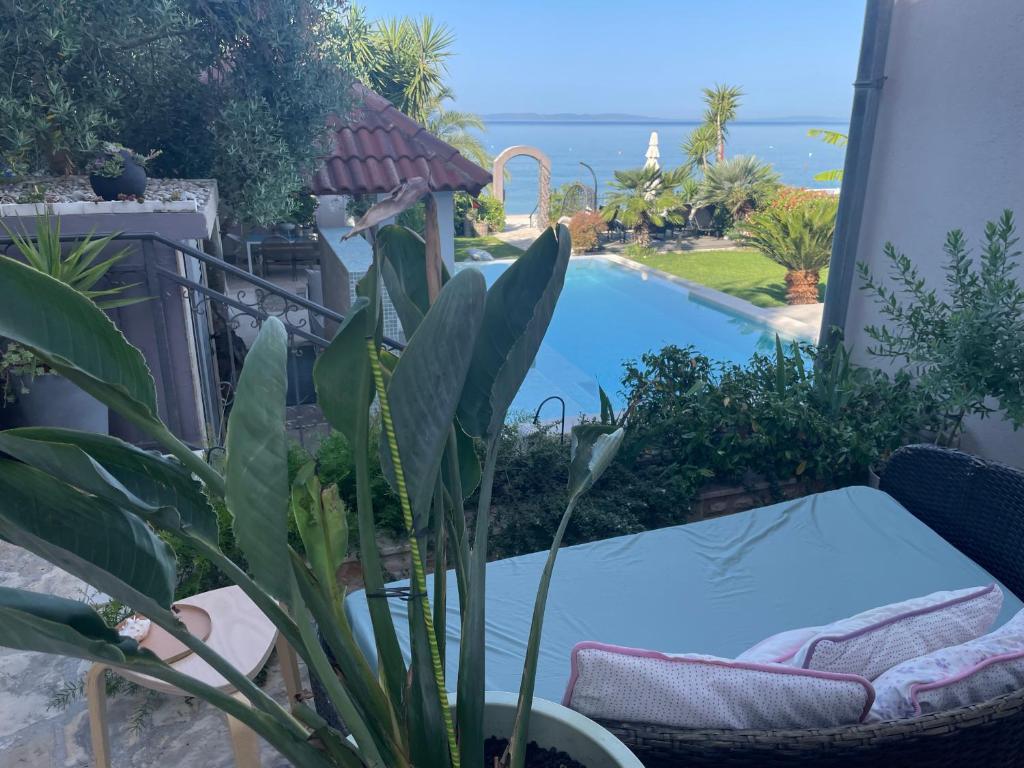 um pátio com uma mesa e uma piscina em Villa Maris- beachfront villa with exclusive pool em Podstrana