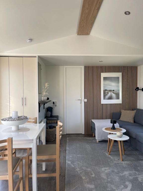 a living room with a couch and a table at Dammhuis Zeeland in Oostkapelle