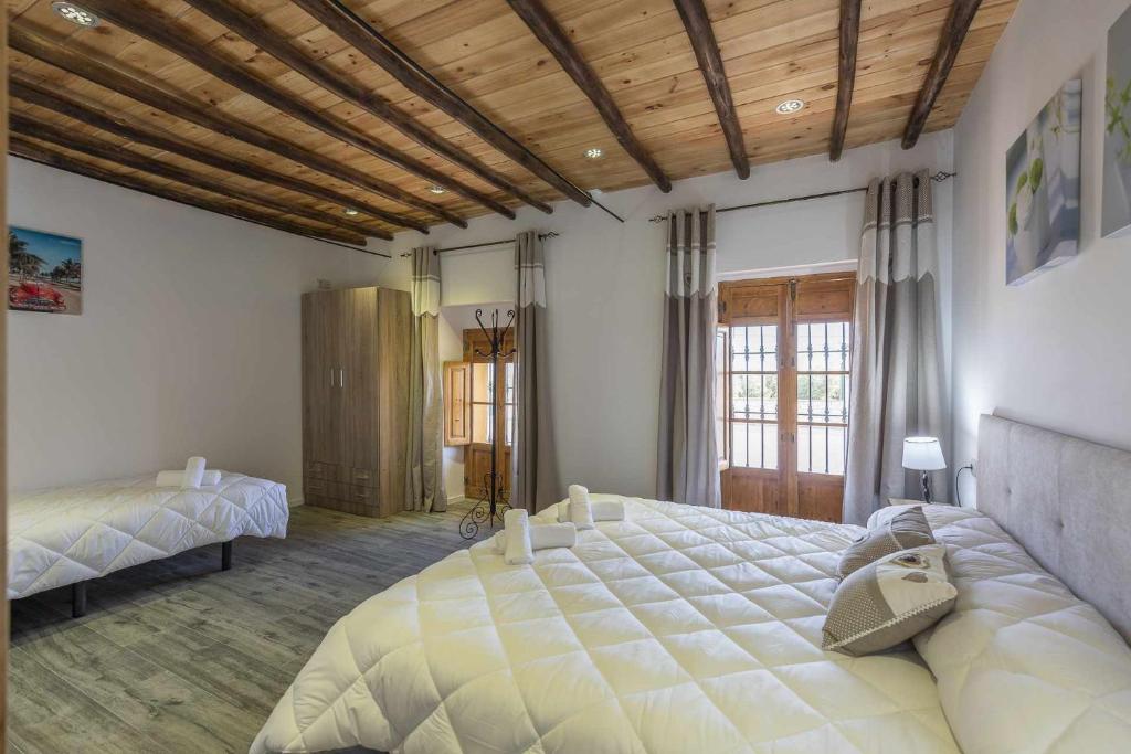 Postel nebo postele na pokoji v ubytování Casa Rural Maimones