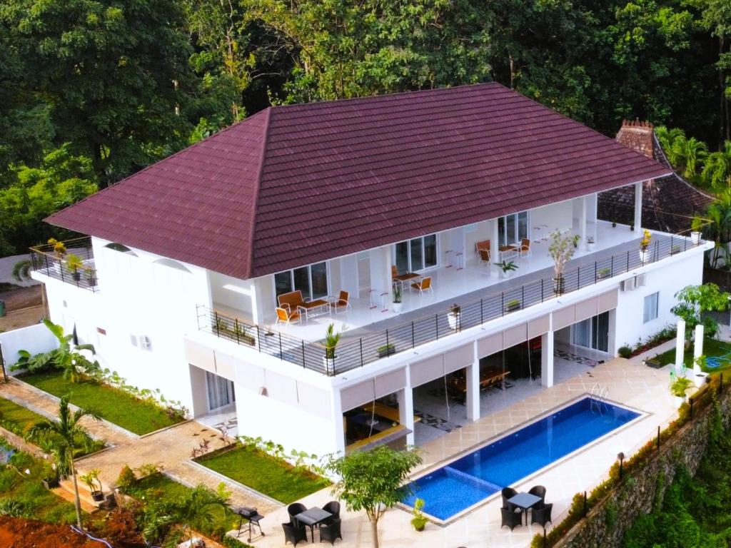 an aerial view of a house with a swimming pool at Garden House Jepara in Jepara