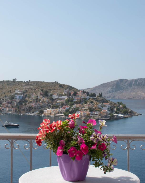 a vase filled with flowers sitting on a table at Marea Apartments in Symi
