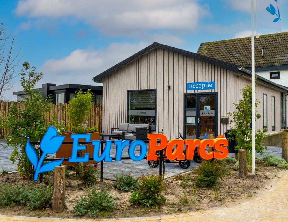 a store with a sign in front of it at EuroParcs De Koog in De Cocksdorp