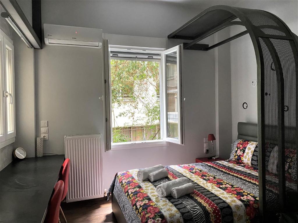 a bedroom with a bed and a large window at Dreamy Central Corner in Thessaloniki