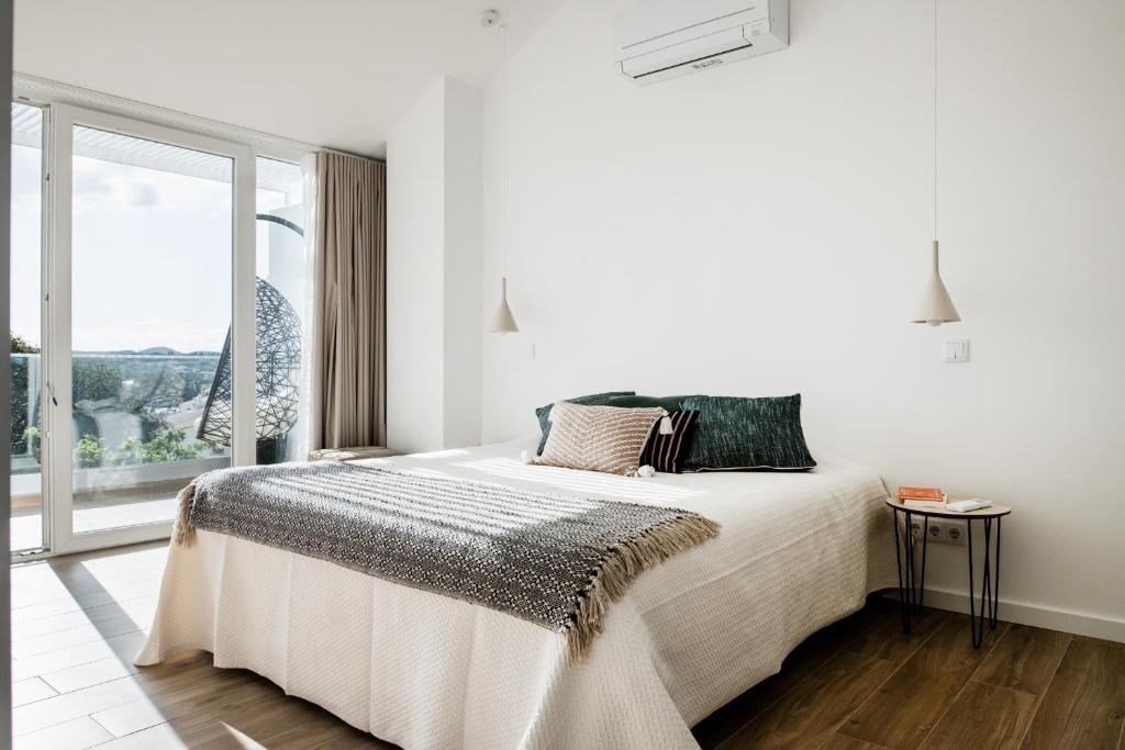 Ένα ή περισσότερα κρεβάτια σε δωμάτιο στο Casa Nova