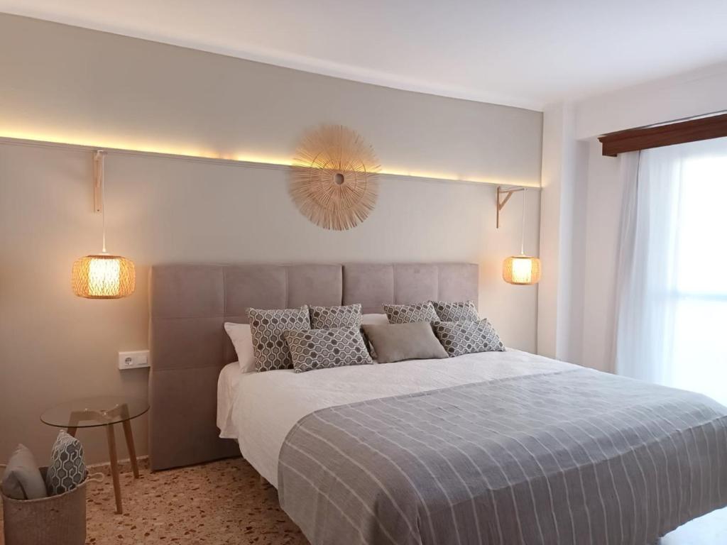 a bedroom with a large bed in a room at Hotel Nou Can Guillem in Cala Figuera