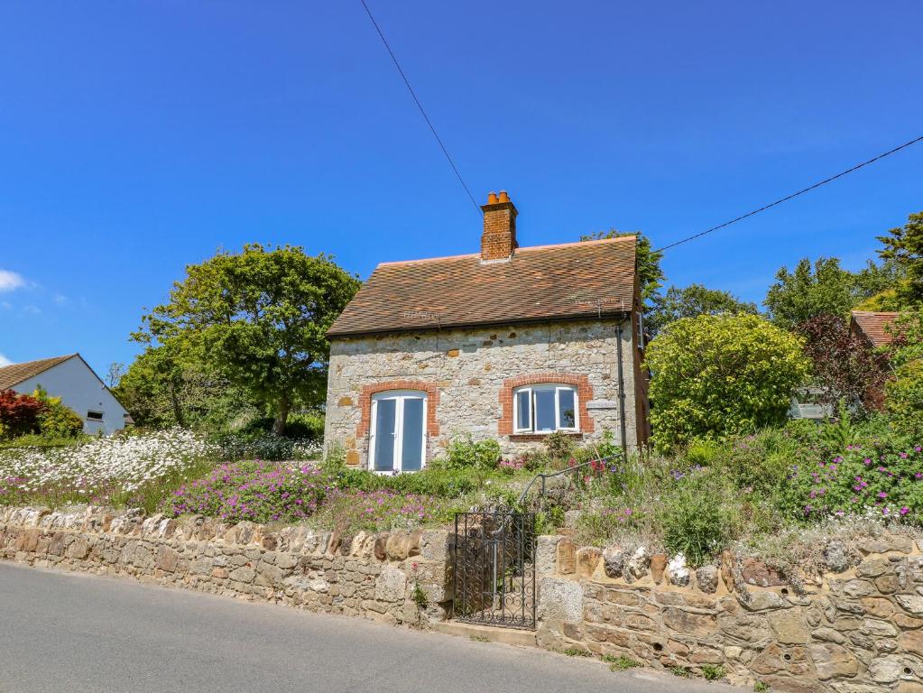 a stone house on the side of a road at Ladylands Cottage in Newport