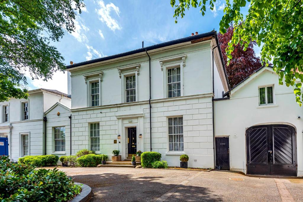 a large white house with a driveway at Edgbaston House in Birmingham