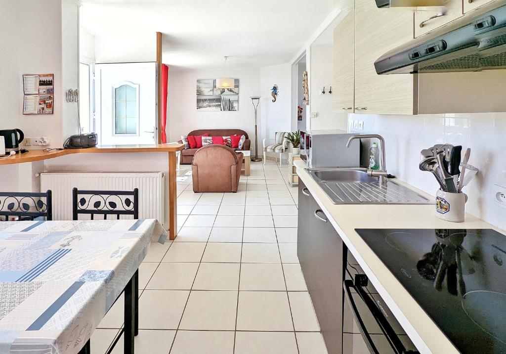 a kitchen with a sink and a counter top at La Villa Ty Reun - Vue mer et Plage à 100m in Plouguerneau