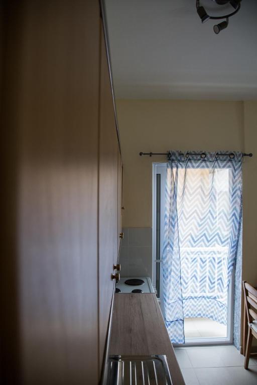 A bed or beds in a room at Blue Theros Apartments
