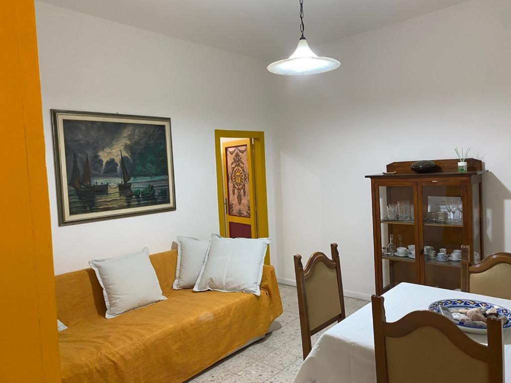 a living room with a couch and a table at Casa Eoliana in Taormina