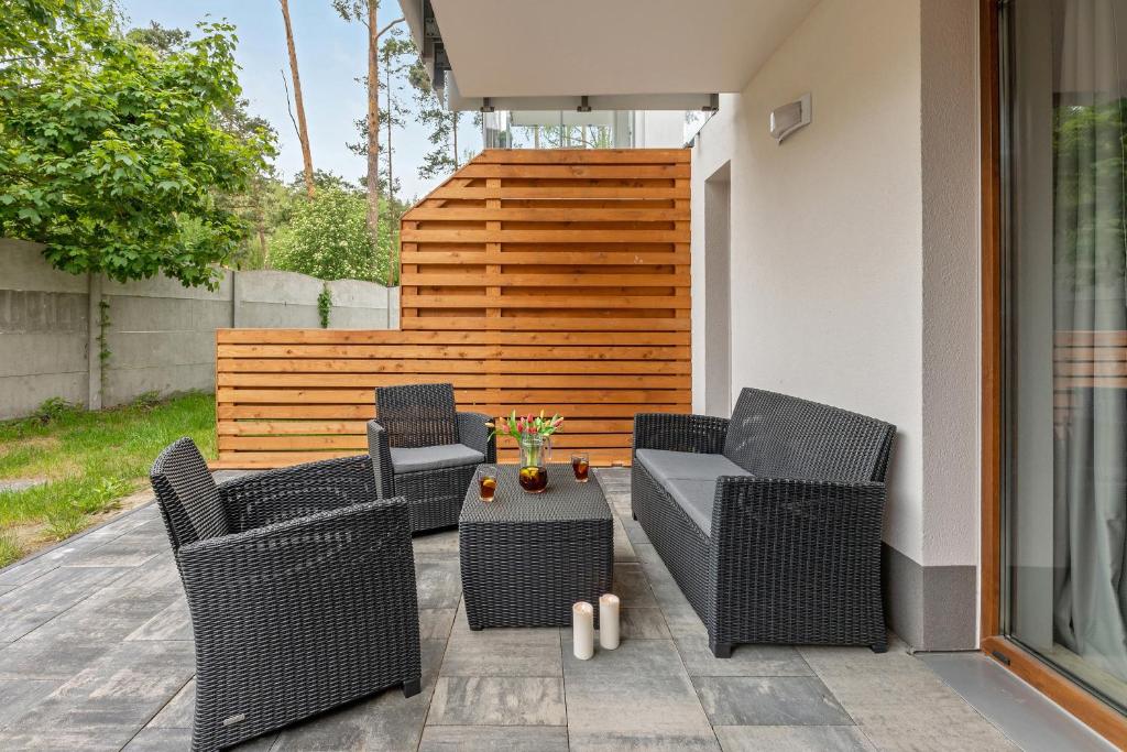 Private tiled patio with wicker seating, central coffee table, tulips and lit candles.