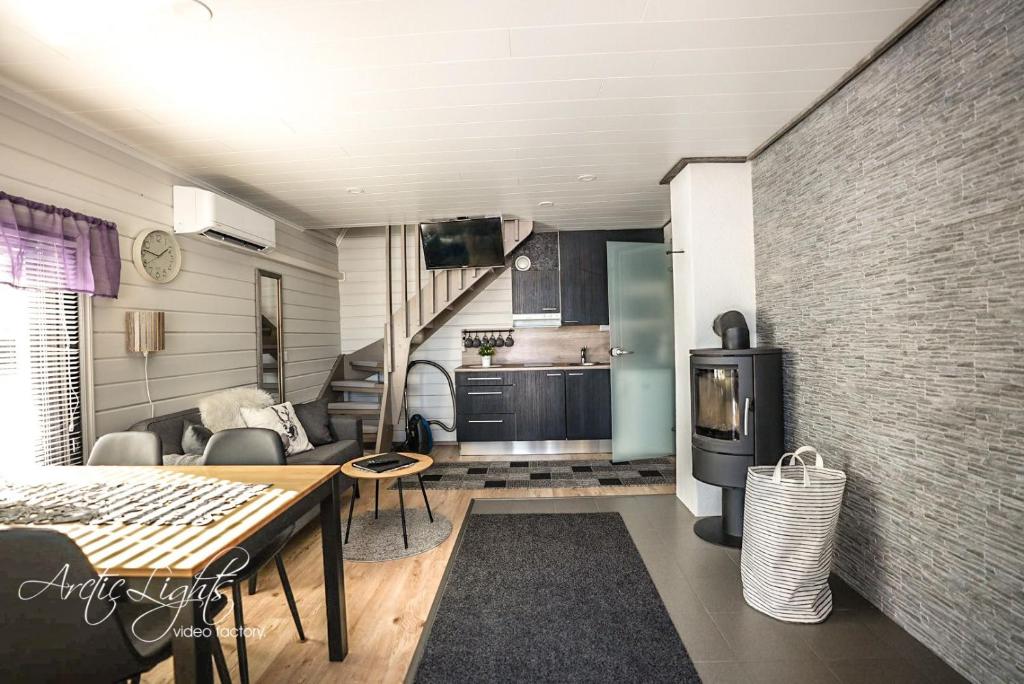 a living room with a table and a kitchen at Aava Sky Village in Aavasaksa