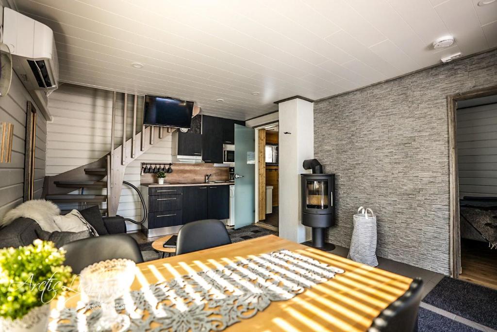a dining room with a table and a kitchen at Aava Sky Village in Aavasaksa