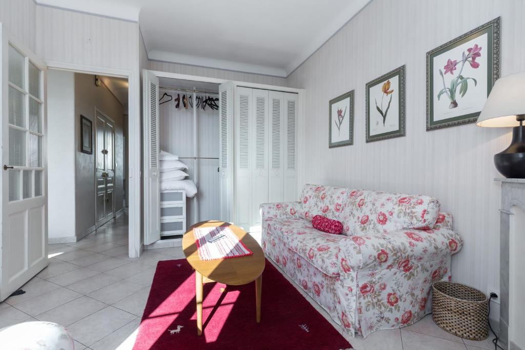 a living room with a couch and a table at Three bedroom two bathroom apartment in center of Cannes on quiet street minutes from the Palais - 2002 in Cannes