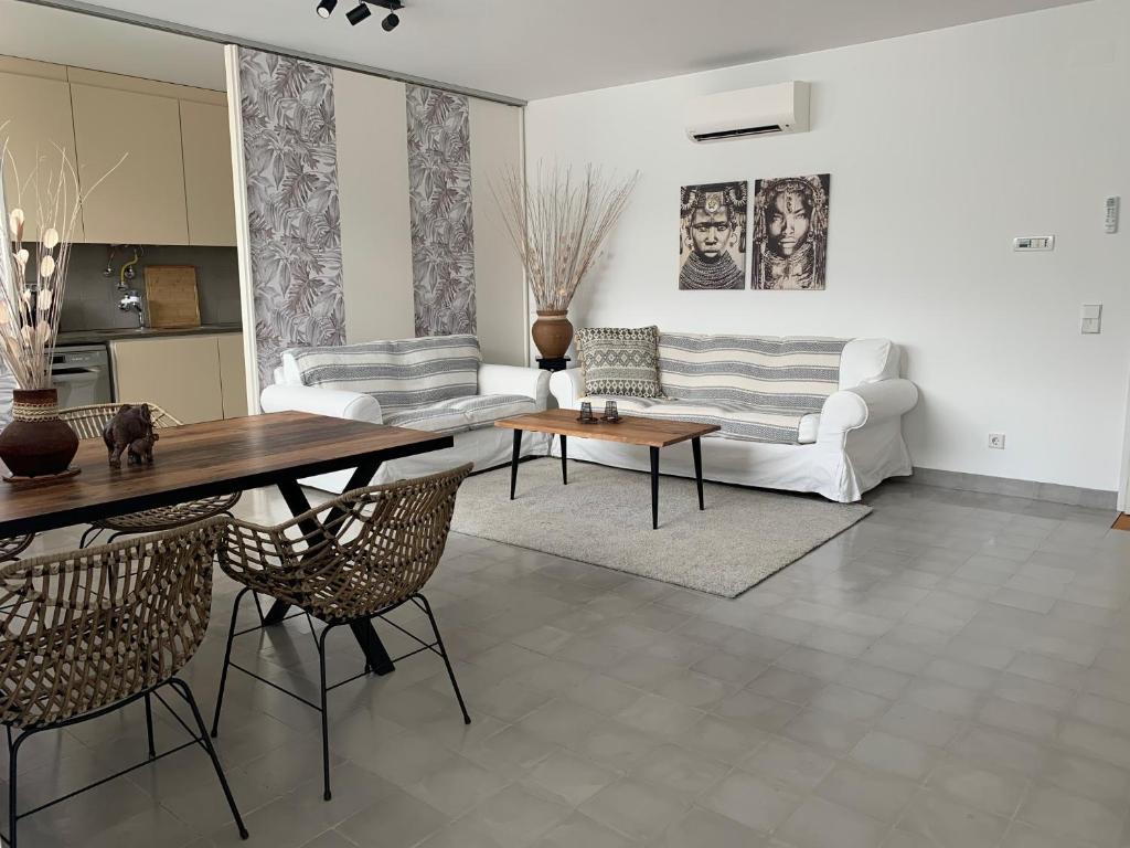 a living room with a table and chairs and a couch at Casa Bamboo Tavira in Tavira