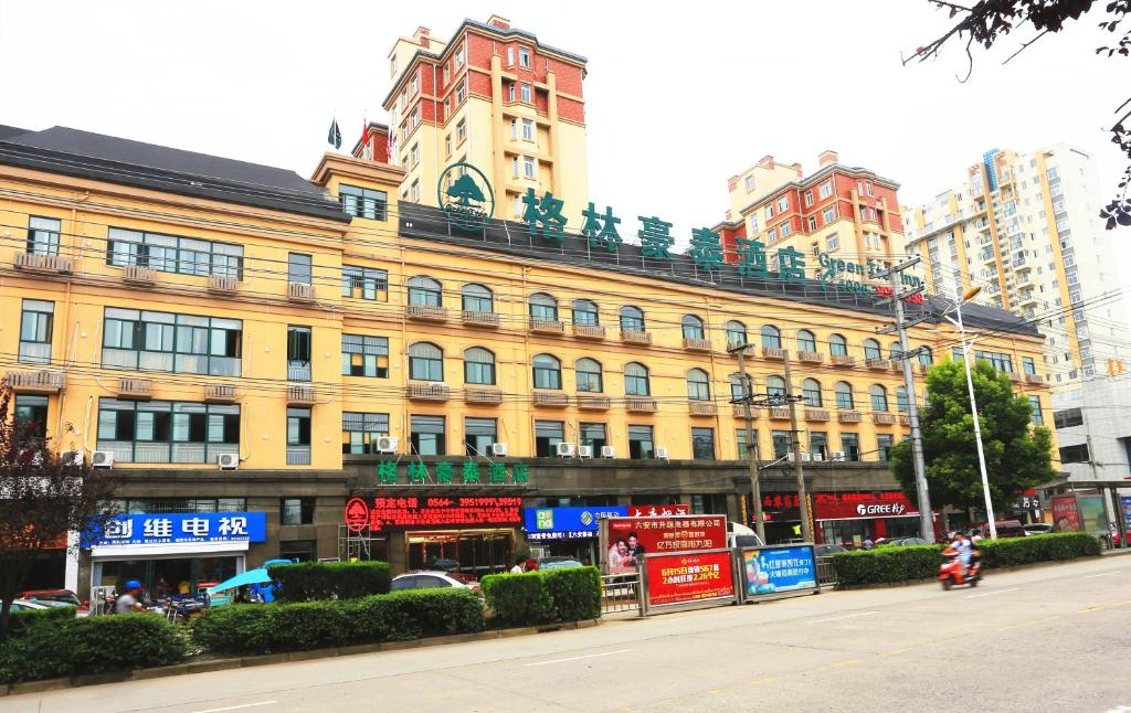 Greentree Inn Mozitan Road Yiwu Small Commodities Wholesale City في Lu'an: مبنى اصفر كبير على جانب شارع