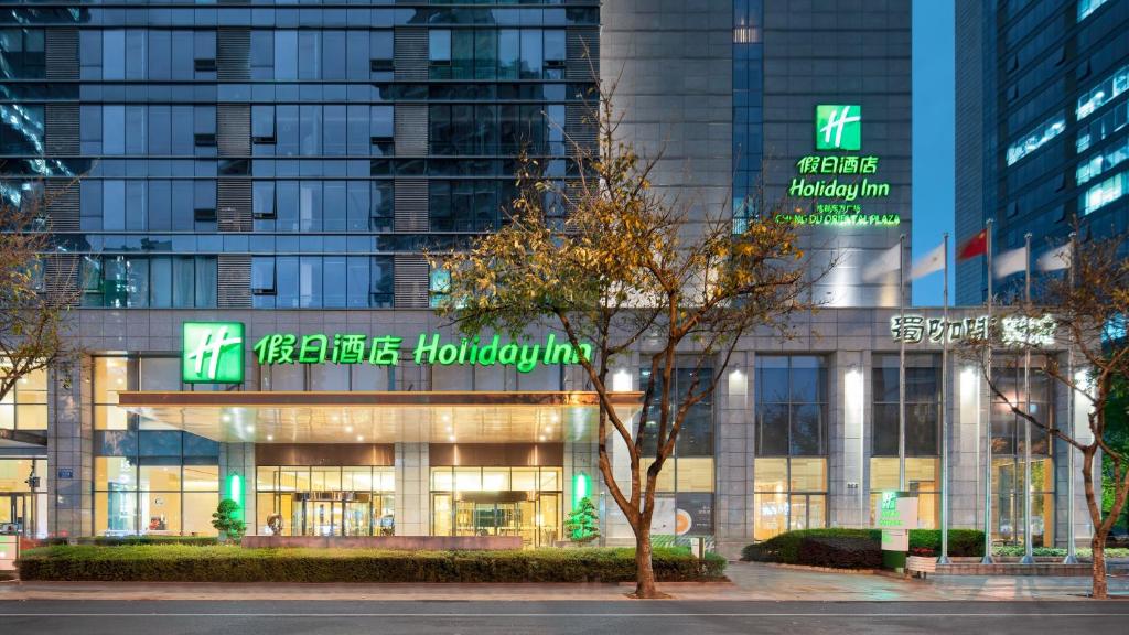 a building with green signs on the front of it at Holiday Inn Chengdu Oriental Plaza in Chengdu