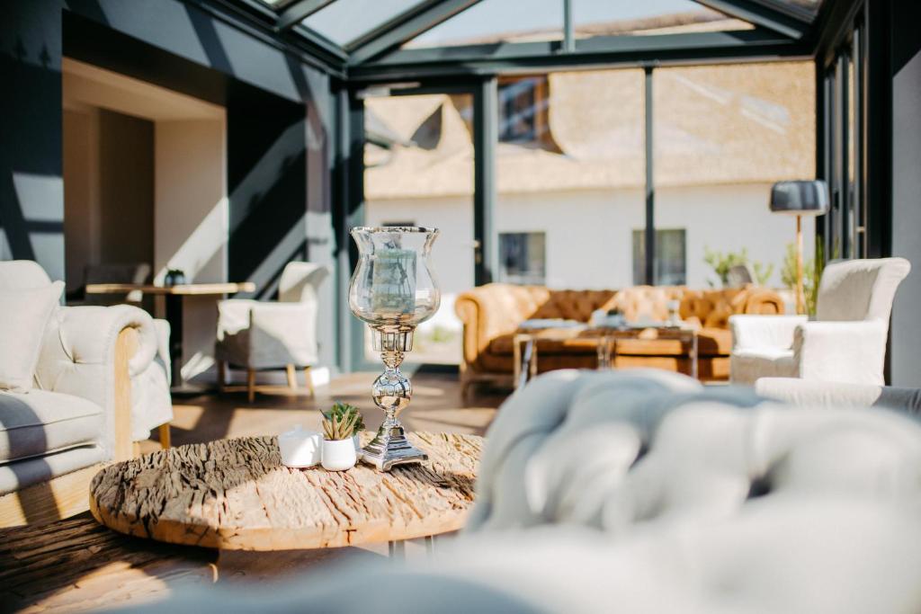 a glass wine glass on a wooden table in a living room at Seaside 43 in Sankt Peter-Ording