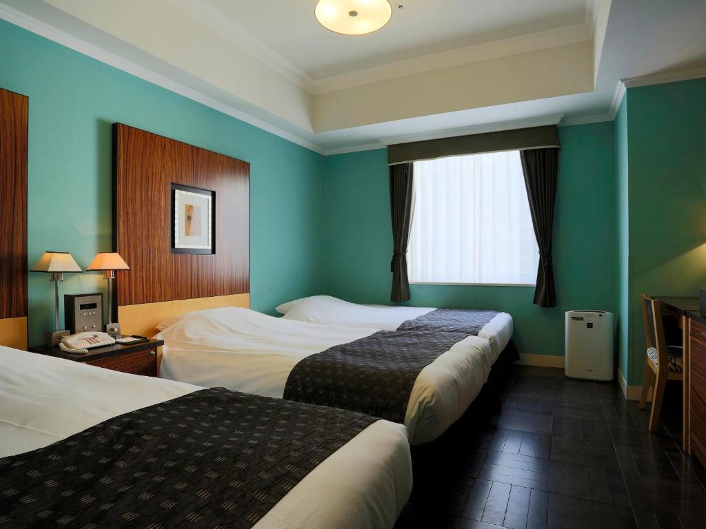 Cama ou camas em um quarto em Hotel Monterey La Soeur Fukuoka