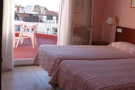 Postel nebo postele na pokoji v ubytování Hostal Solimar