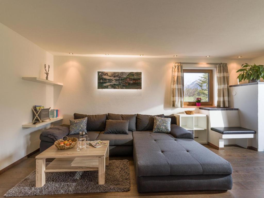a living room with a couch and a table at Appartement Waldmoos in Ellmau