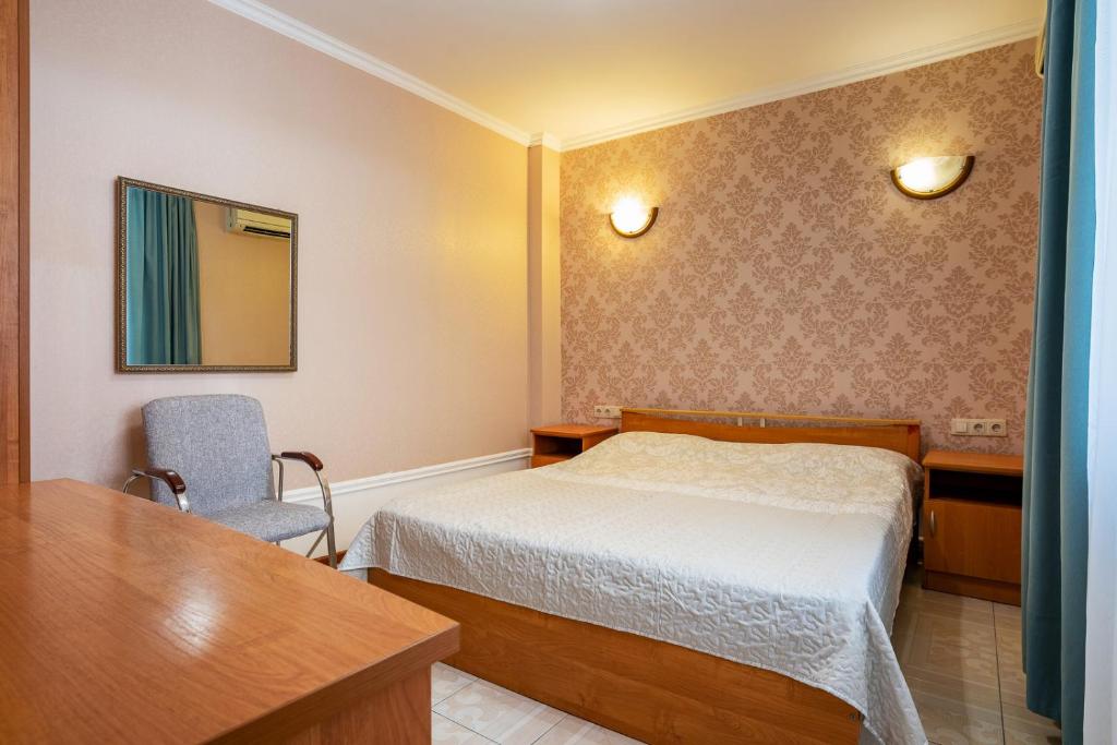 En eller flere senge i et værelse på Aleksandrit Guest house