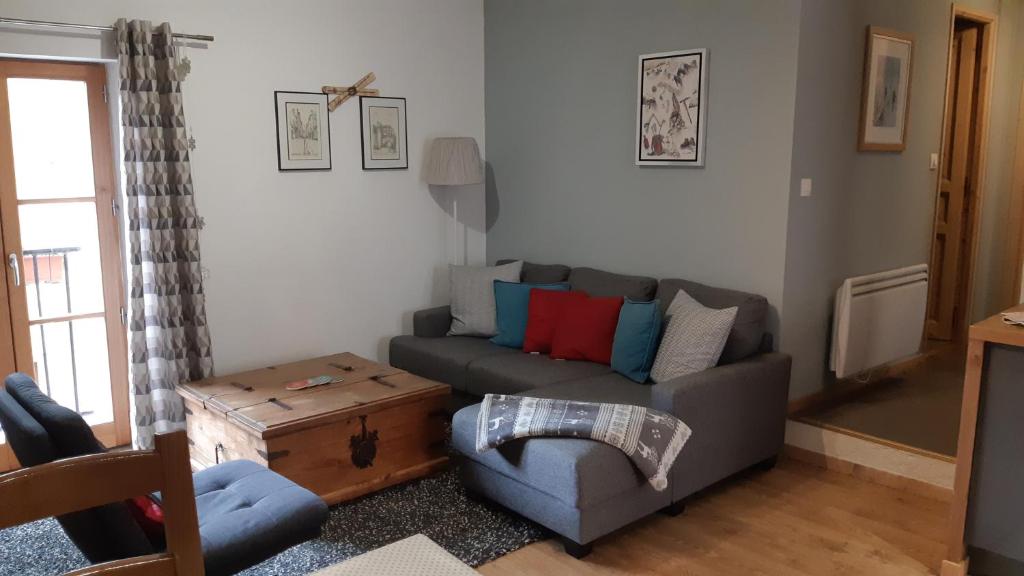 a living room with a couch and a table at Près des Forts in Briançon