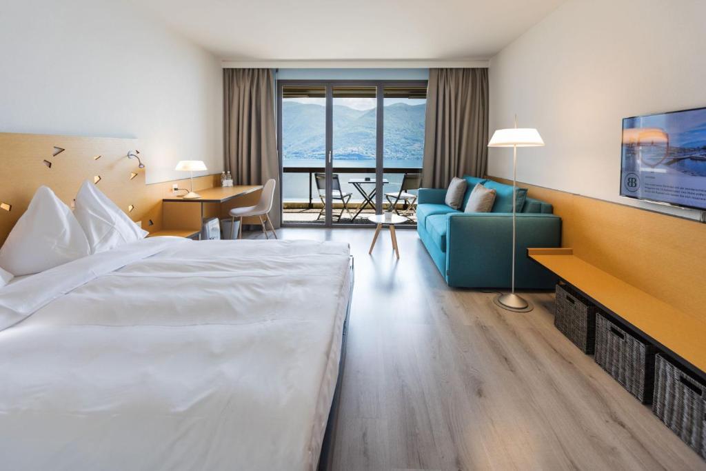 Postel nebo postele na pokoji v ubytování Parkhotel Brenscino Brissago