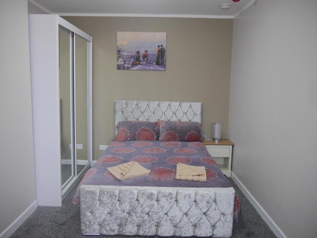 a bedroom with a large bed with a large window at Mermaid Holiday Flats in Blackpool