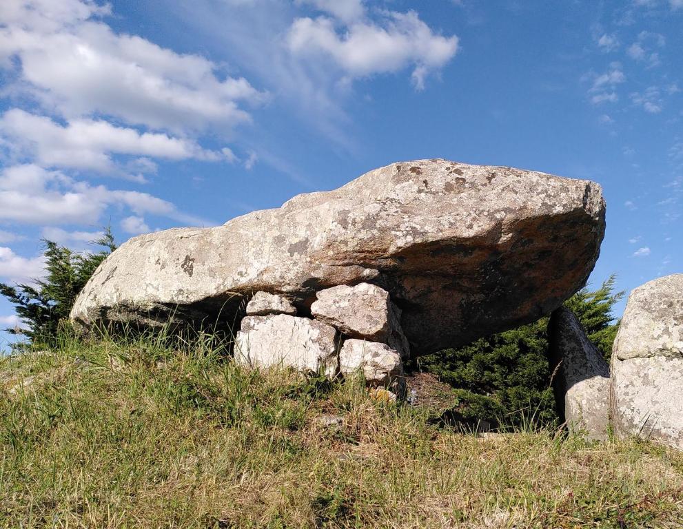 a large rock sitting on top of a hill at Le studio du dolmen à Plouharnel in Plouharnel