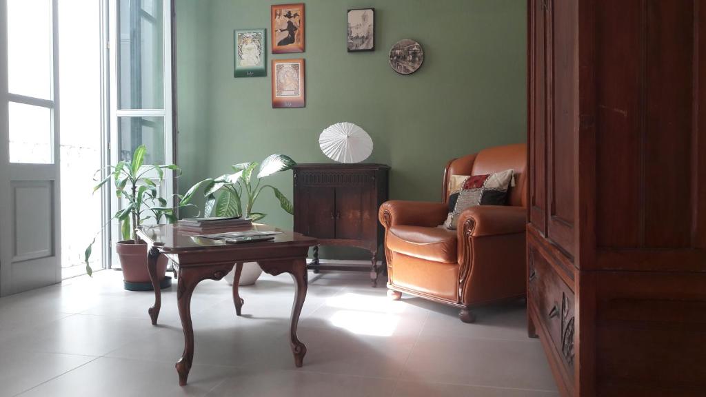 salon z krzesłem i stolikiem kawowym w obiekcie Belle Époque w mieście Iglesias