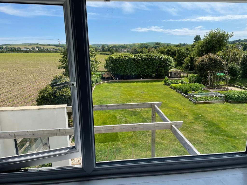 a window with a view of a yard at Cottars in Winfrith Newburgh